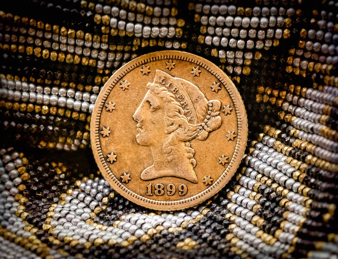 Obverse of an 1899 Liberty Head Half Eagle, showing Liberty facing left in a coronet lettered LIBERTY, thirteen stars around the rim and the date 1899 below the bust