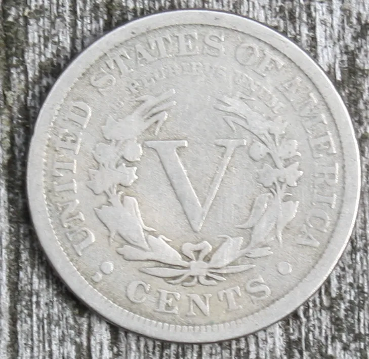 Circulated With CENTS reverse of a 1912-D Liberty Head V nickel, showing the narrow strip of field between the left dot and the C of CENTS where the mint mark is placed