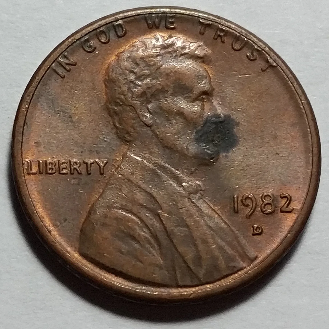 Obverse of a 1982-D Lincoln cent of the Large Date style, the digits of 1982 broad and heavy with the 2 sitting on a flat base