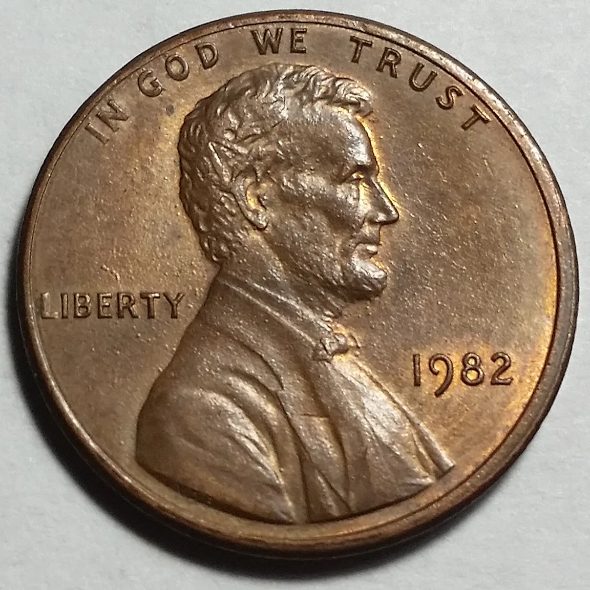 Obverse of a 1982 Philadelphia Lincoln cent of the Small Date style, with no mint mark below the date