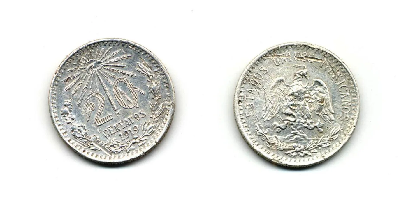 Obverse and reverse of a Mexican twenty centavos of 1919, a cap and rays above the value and a left-facing eagle on the other side