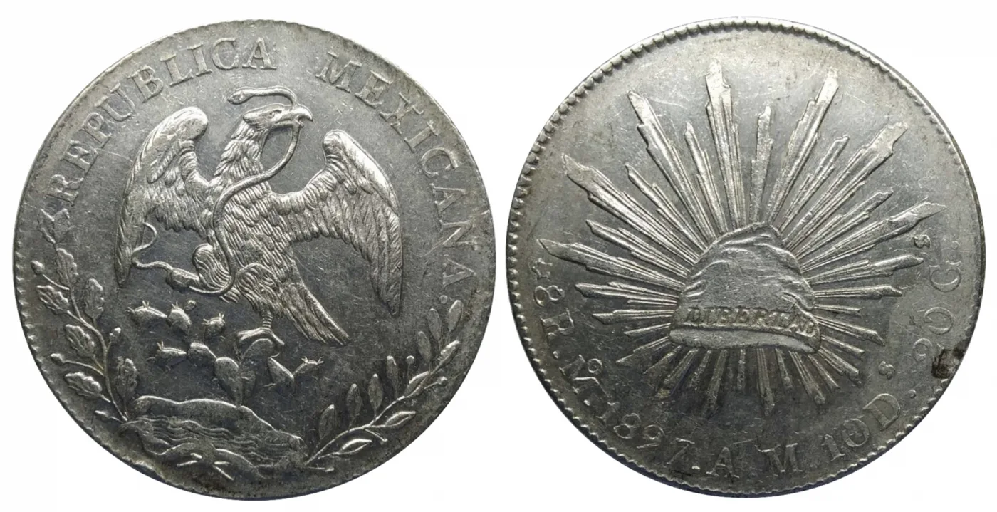 Obverse and reverse of an 1897 Mexican eight reales, an eagle on a cactus with REPUBLICA MEXICANA around it and a liberty cap radiating rays