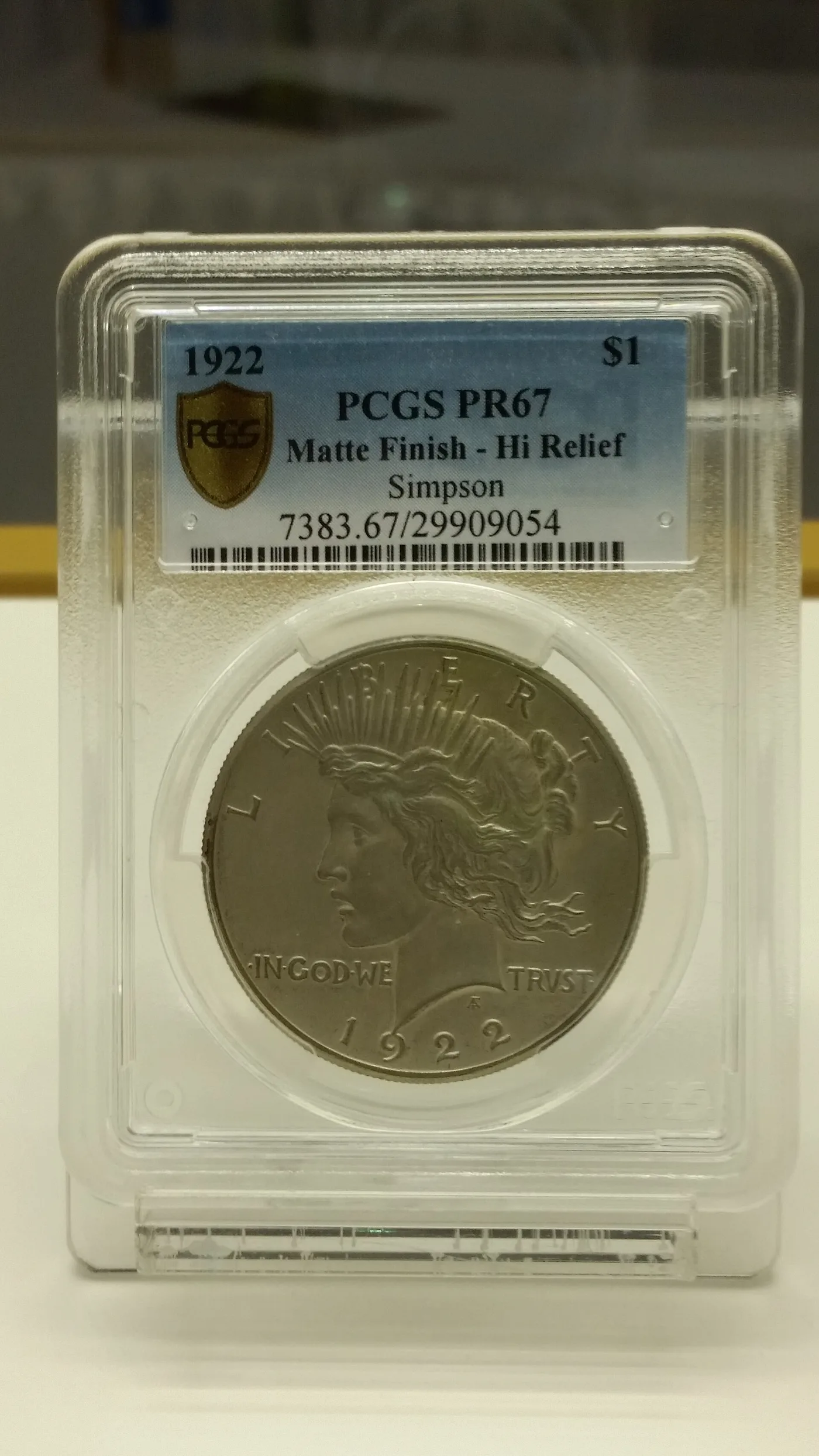A 1922 Peace dollar sealed in a PCGS holder labelled PR67 Matte Finish Hi Relief, the coin showing a dull non-reflective surface