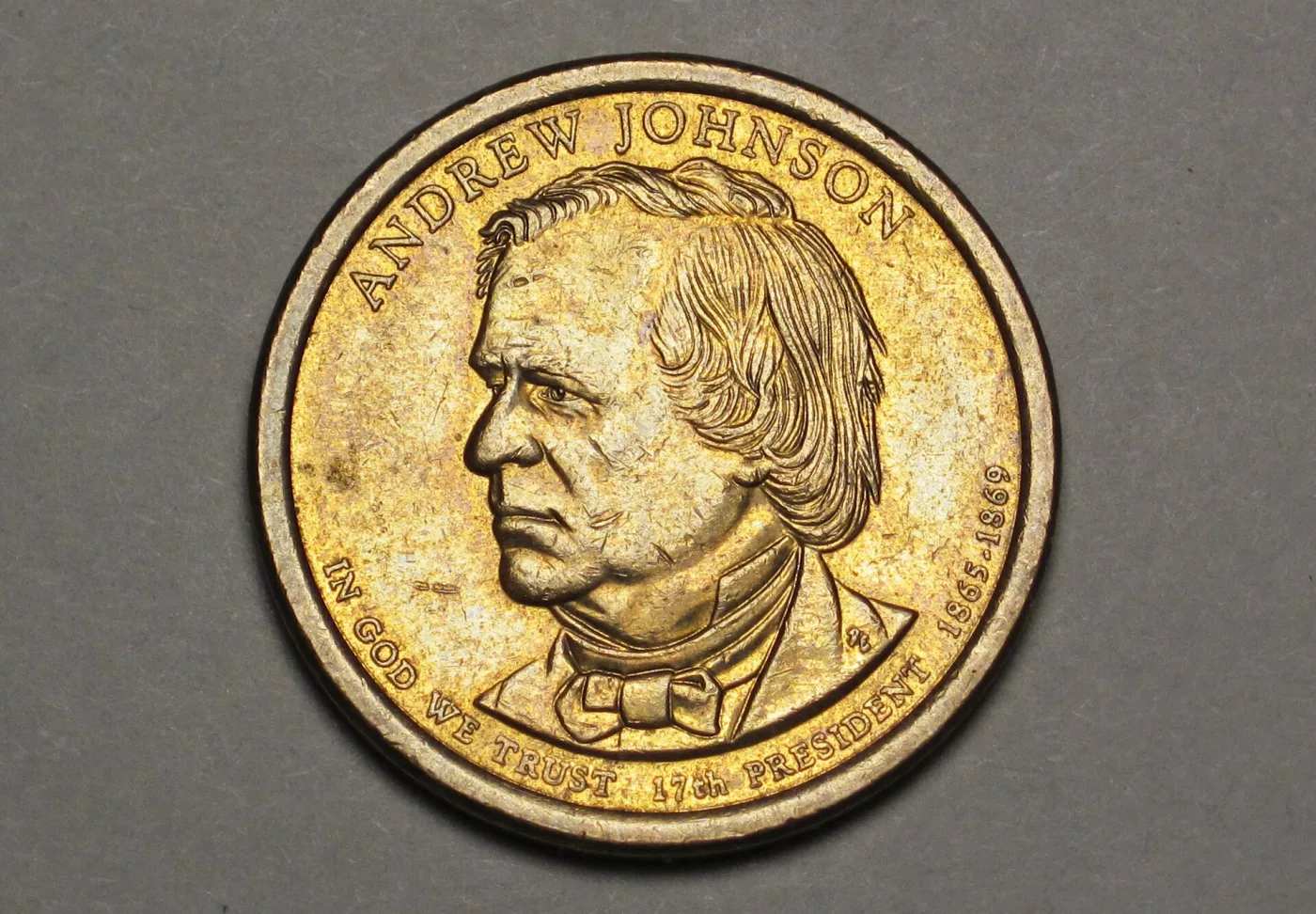Obverse of a 2011 Andrew Johnson dollar, the name arched above the portrait and IN GOD WE TRUST curving along the bottom rim beside 17th PRESIDENT 1865-1869