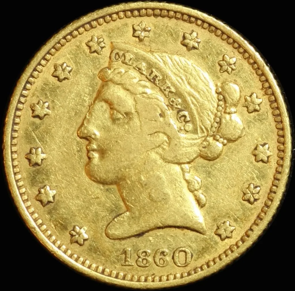 Obverse of an 1860 Clark and Company five dollar gold piece, a Liberty head facing left inside thirteen stars with CLARK and CO. lettered on her coronet and the date 1860 below