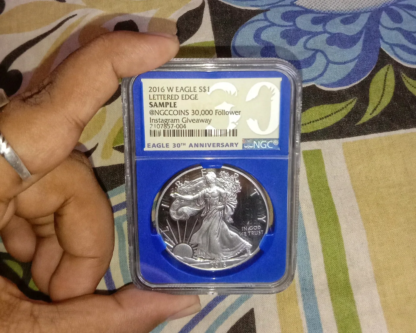 A proof American Silver Eagle held in an NGC holder, the label reading 2016 W Eagle S dollar 1, Lettered Edge, Eagle 30th Anniversary above a barcode