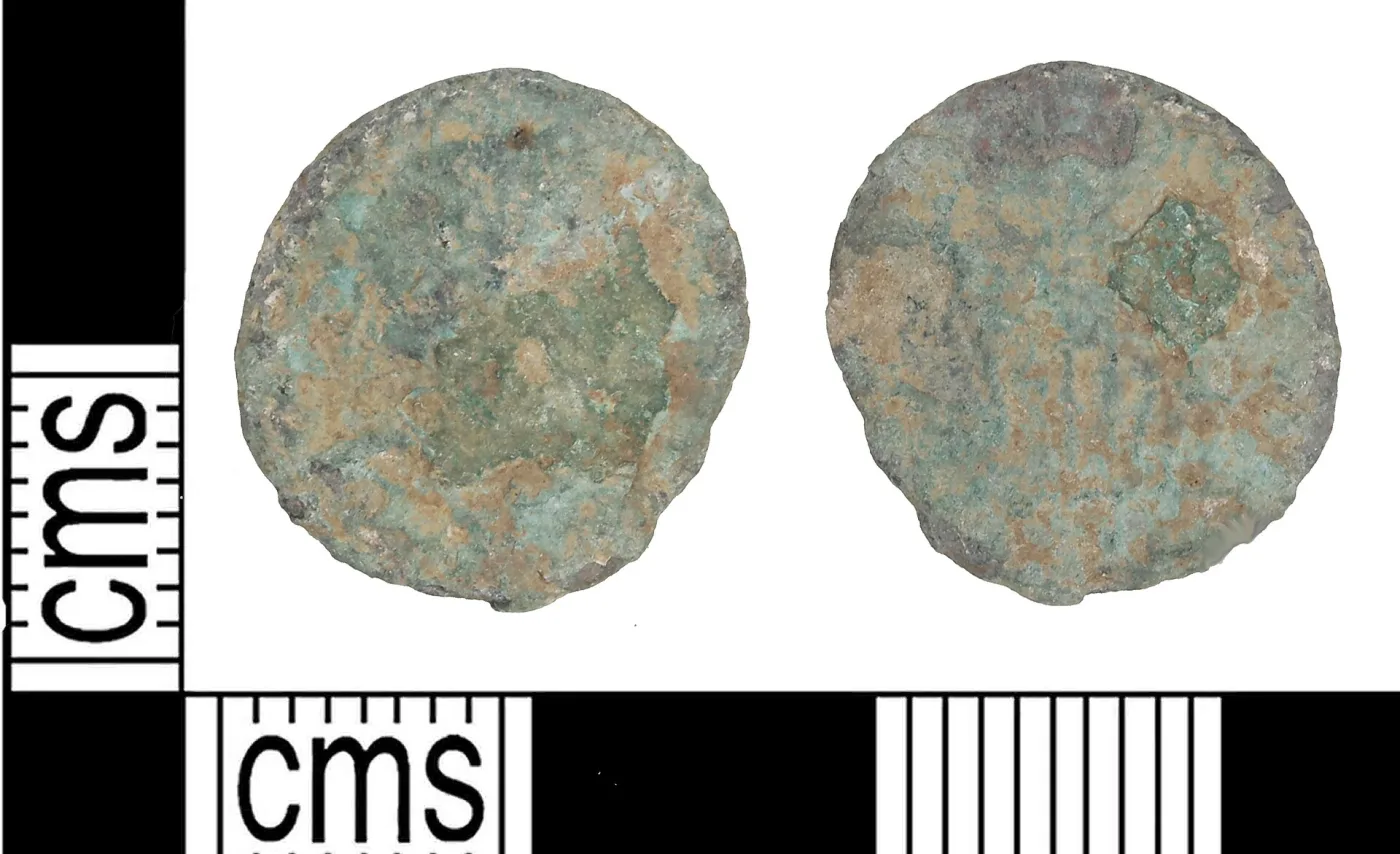 Obverse and reverse of a worn, green-crusted Roman nummus; on the reverse two upright figures with tall standards between them are just visible