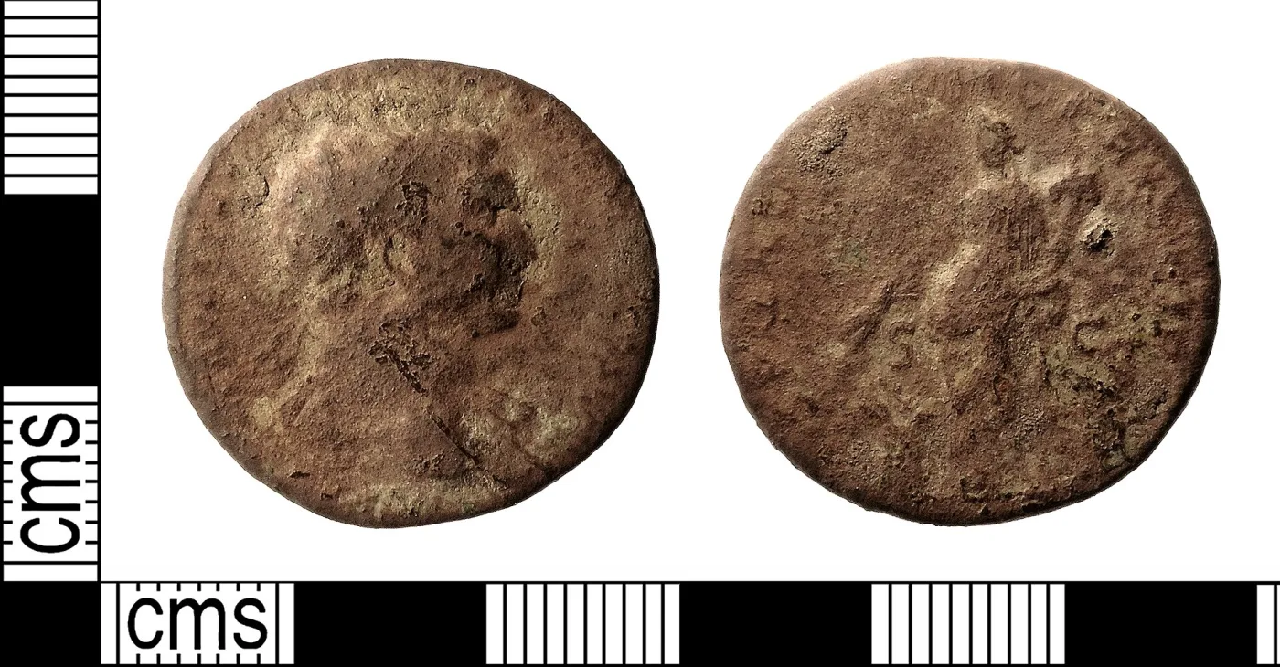 Obverse and reverse of a worn Roman dupondius of Trajan: a radiate head facing right, and a standing female figure between the letters S and C