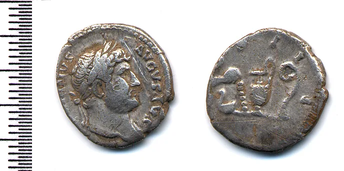 Silver denarius of Hadrian, the bearded, laureate emperor facing right with AVGVSTVS legible in the legend, beside its worn reverse