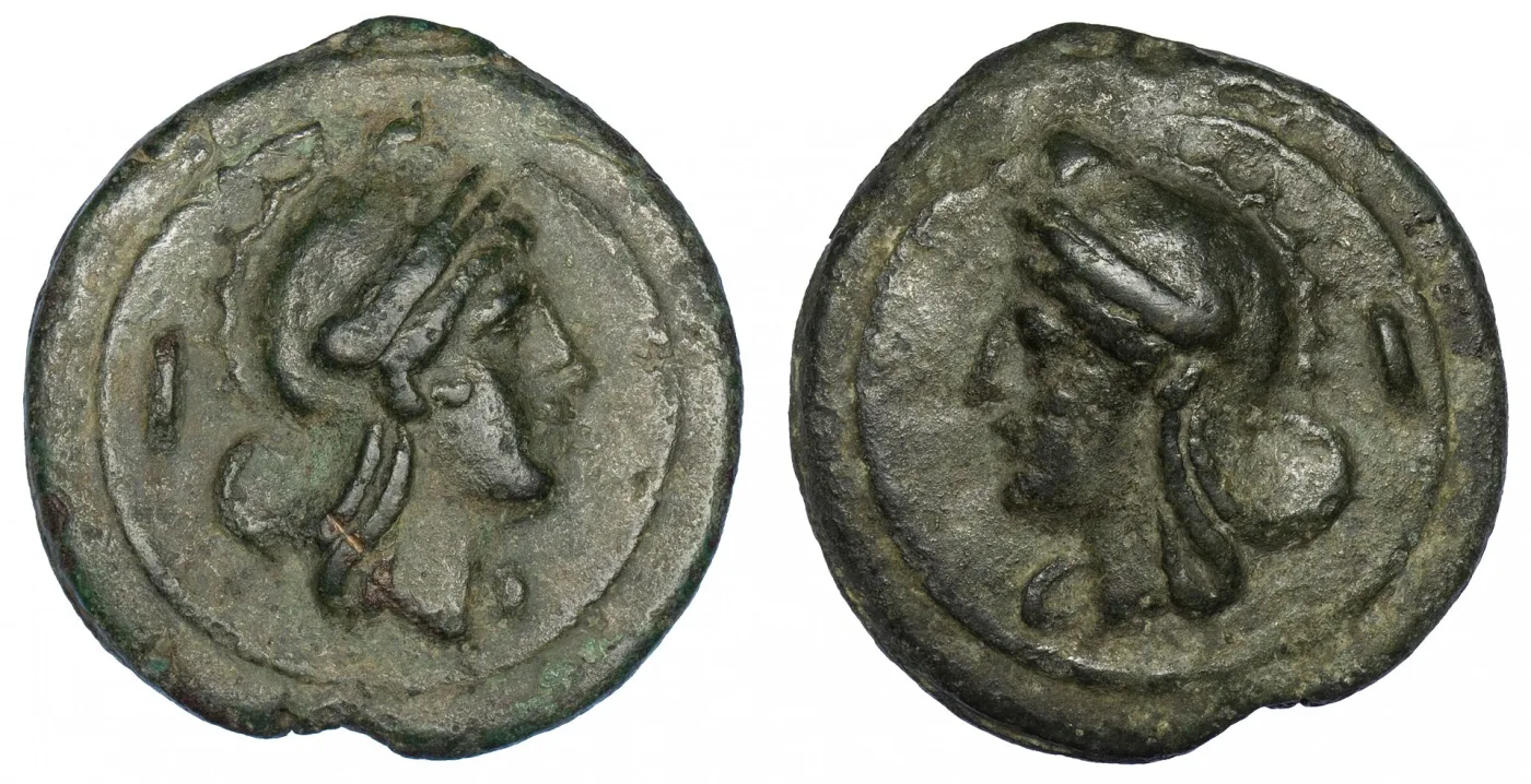 Both sides of a cast Roman bronze as, a helmeted head on each face with an upright bar beside it