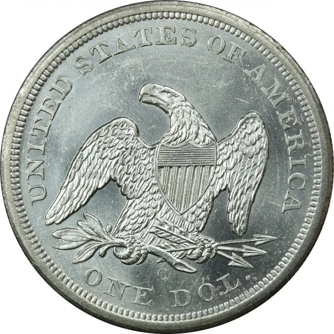 Reverse of an 1860-O Seated Liberty dollar showing the heraldic eagle with an empty field above its head and the O mint mark between the tail feathers and ONE DOL.