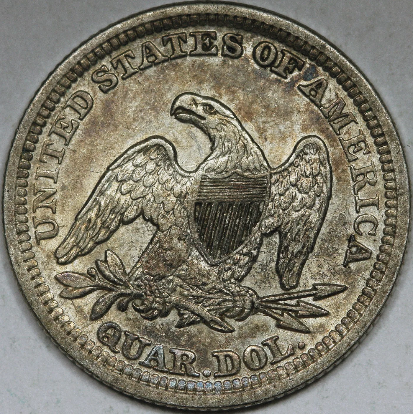 Reverse of an 1854 Seated Liberty quarter with a plain empty field around the eagle, no rays and no motto, and QUAR. DOL. below