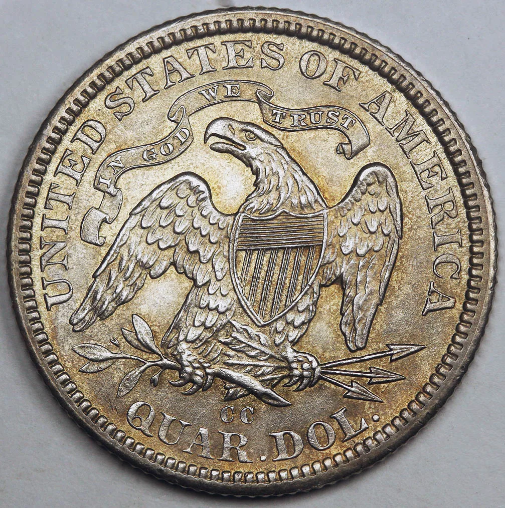 Reverse of an 1877-CC Seated Liberty quarter with IN GOD WE TRUST on a scroll above the eagle and a CC mint mark in the field below the eagle, above QUAR. DOL.