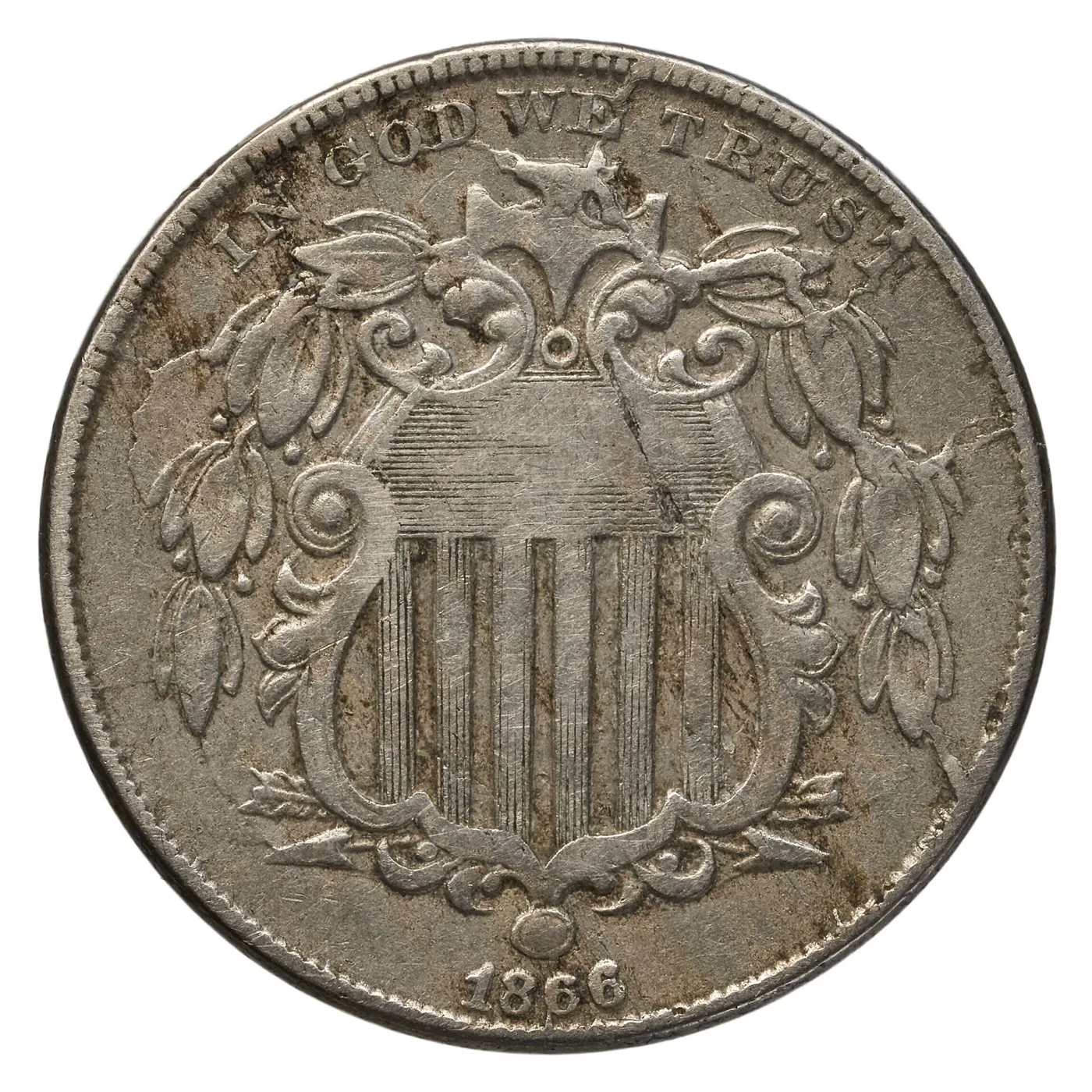 Obverse of an 1866 Shield nickel showing the Union shield, IN GOD WE TRUST above and the date 1866 below