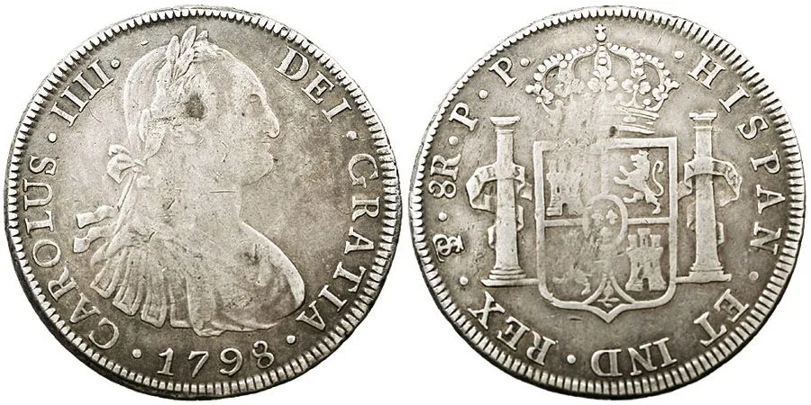 Obverse and reverse of a silver portrait eight reales, a draped bust of a king facing right on one side and a crowned shield between two pillars on the other