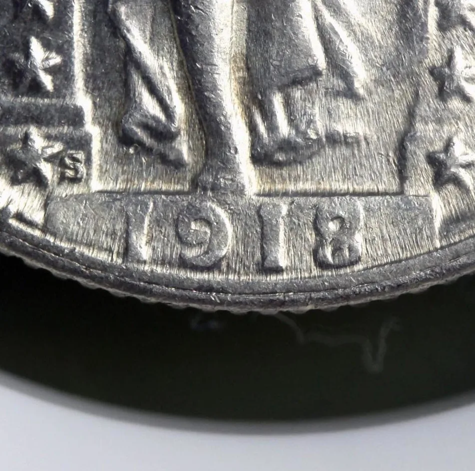 Magnified view of the date on a 1918/7-S Standing Liberty quarter, showing an extra stroke crossing the loops of the 8 and the S mint mark to the upper left