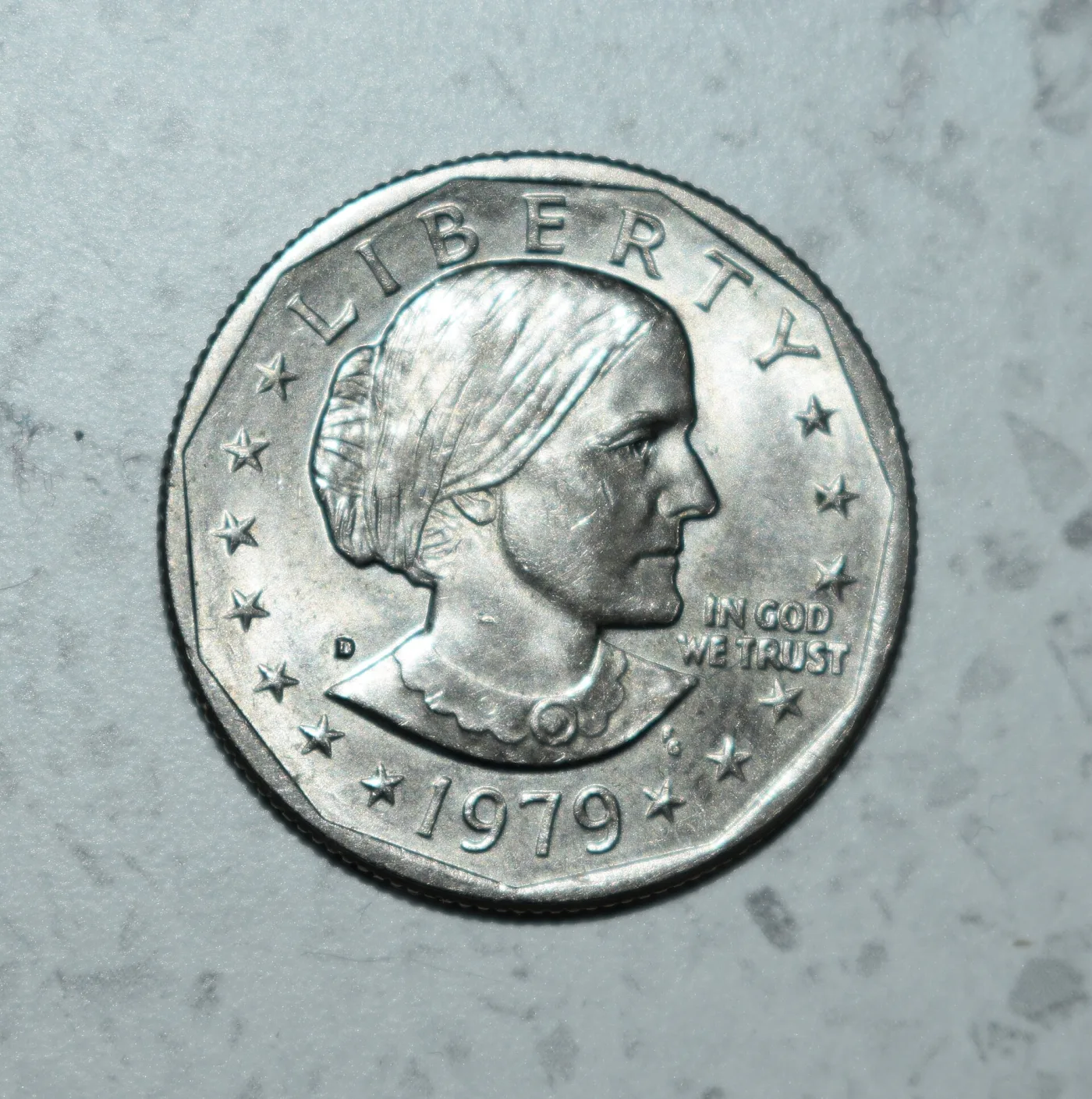 Obverse of a 1979-D Susan B. Anthony dollar with a small D in the left field beside the base of the neck