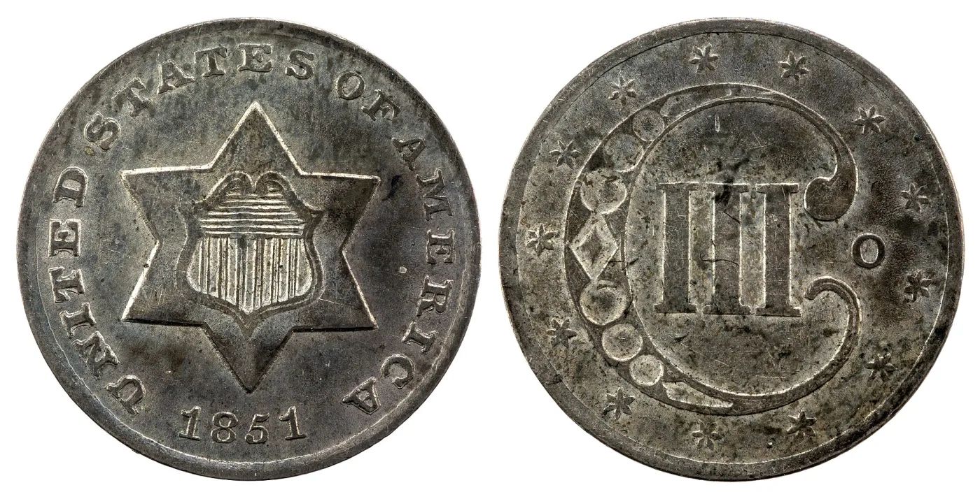 Obverse and reverse of an 1851-O silver three cent piece, showing the six-pointed star with shield and the Roman numeral III inside an ornamented C with the O mint mark