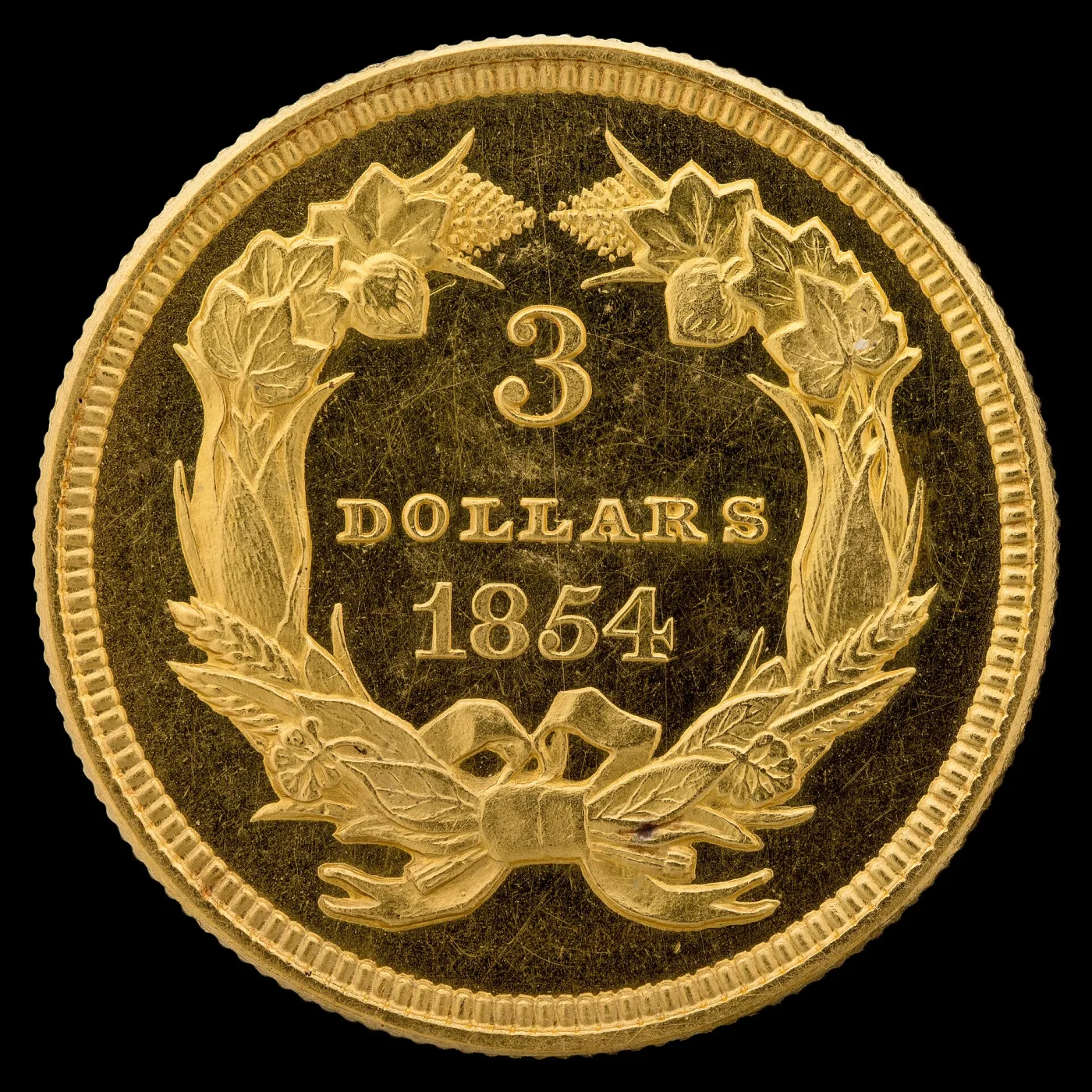 Reverse of an 1854 Three Dollar Gold piece with no mint mark, the word DOLLARS in narrow, thin-stroked letters