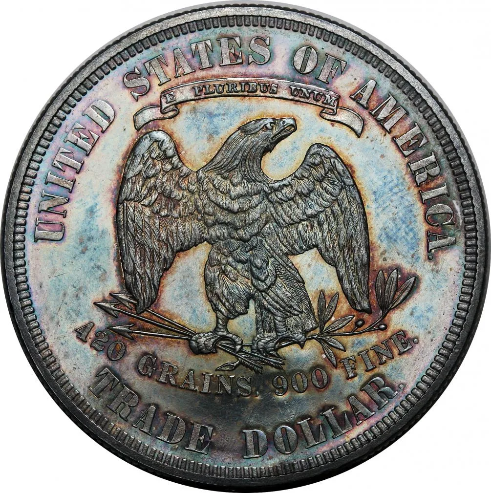 Toned reverse of an 1880 proof Trade Dollar, the olive branch and its berry sitting below the level of the eagle's claw