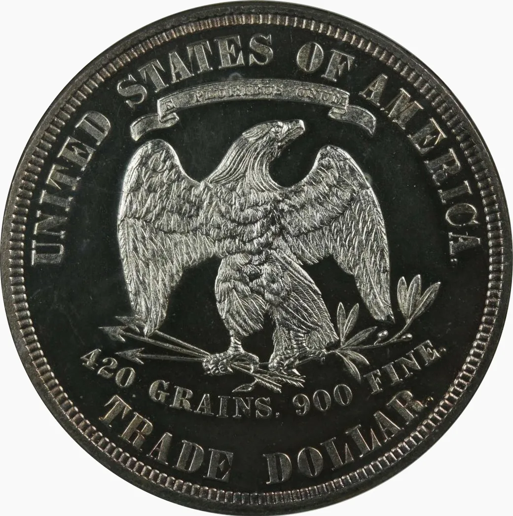 Reverse of an 1883 proof Trade Dollar with the E PLURIBUS UNUM banner above the eagle and the inscriptions 420 GRAINS, 900 FINE and TRADE DOLLAR below it