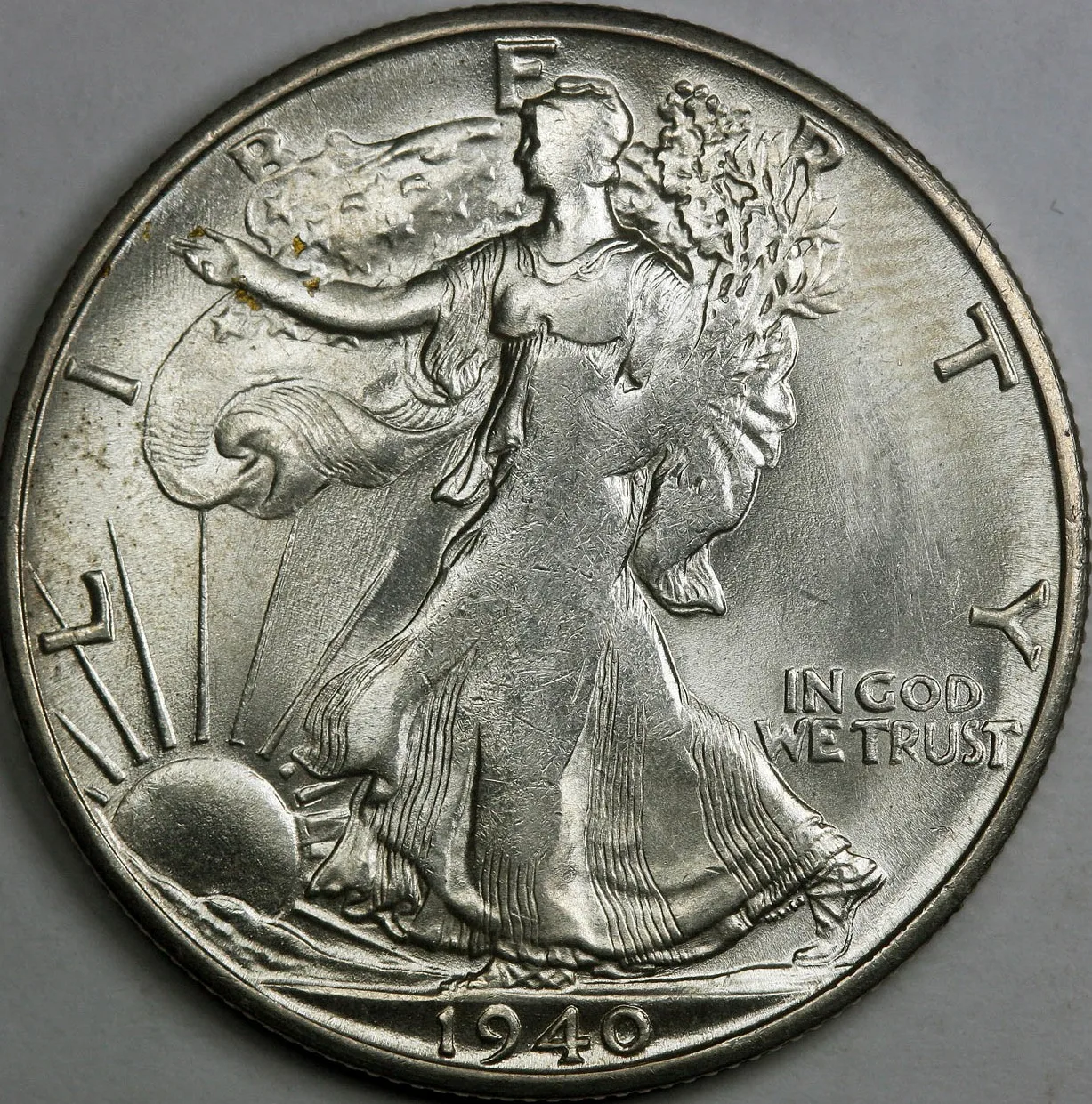 Obverse of a weakly struck 1940-S Walking Liberty half dollar with soft detail in Liberty's head, hand and the stars on the flag