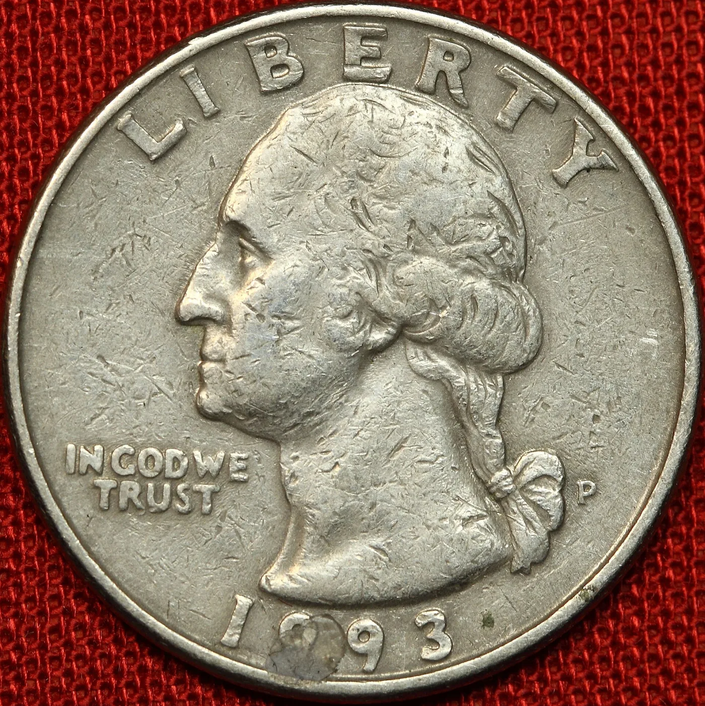 Close-up of a 1993-P Washington quarter obverse with the P mint mark to the right of the hair ribbon at the three o'clock position
